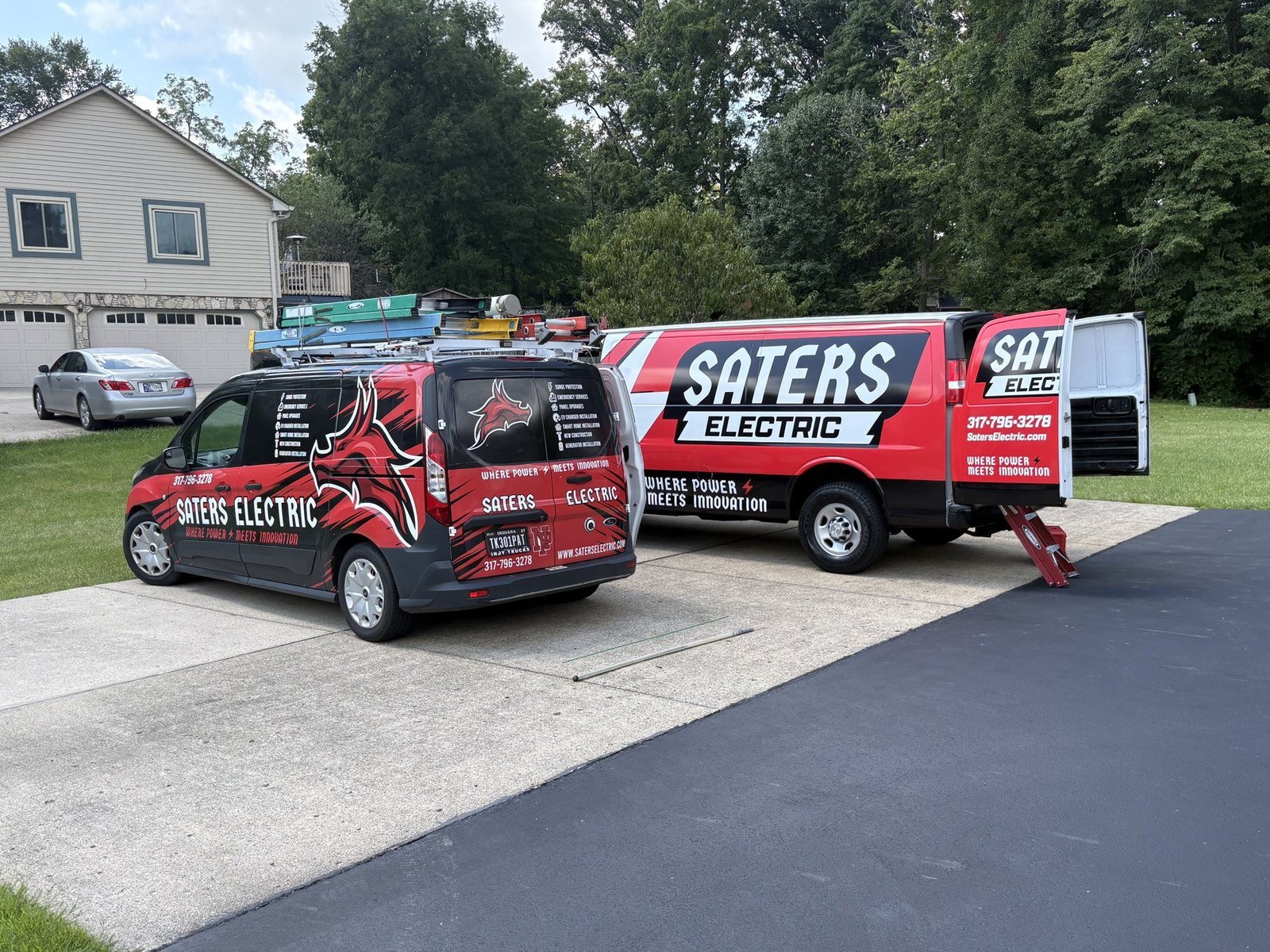Two Saters Electric service vans at a home electrical job in Central Indiana