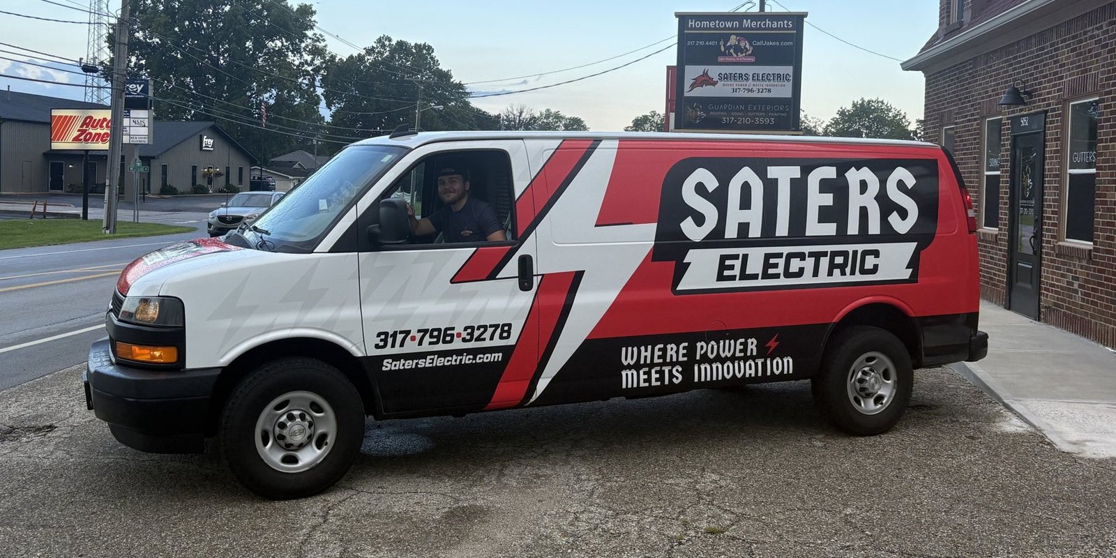 Saters Electric van outside the Hometown Merchants sign in New Palestine, IN